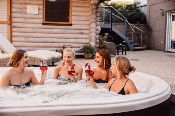 Group of young women having fun in hot tub whirlpool outdoors 
Bachelorette ladies night with women pool and drinks
Photo taken outdoors in natural sunlight in summer